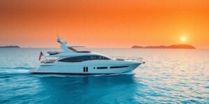 Luxury yacht cruising turquoise waters at sunset.