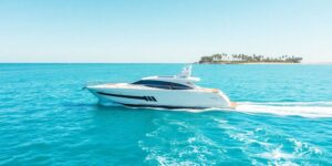 Luxury yacht cruising on clear ocean water.