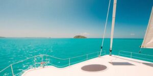 Luxury yacht sails Caribbean, turquoise water, sunny.