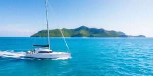 Sailing yacht glides across turquoise Caribbean waters.