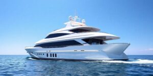 Luxurious cruiser yacht sailing on clear blue water.