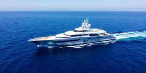 Sleek 54m superyacht cruising on blue ocean waters.