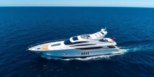 Luxurious yacht sailing on calm, blue ocean waters.