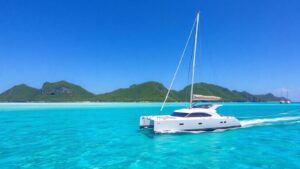 Catamaran sailing on turquoise water near US Virgin Islands.