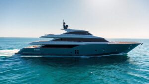 Modern Burgess yacht sailing on a clear blue sea.