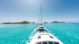Catamaran sailing in the BVI with islands and beaches.
