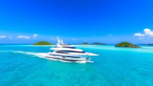 Luxury yacht sailing in clear turquoise Bahamian waters.