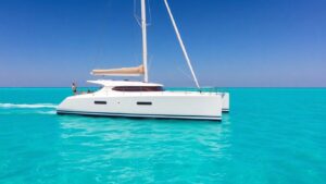 Moorings 4200 catamaran sailing on a clear blue ocean.