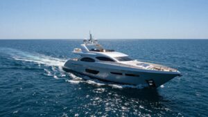 Modern 40-foot yacht sailing on a clear blue ocean.