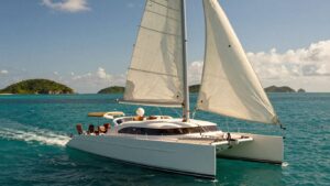 Luxury catamaran sailing in clear turquoise waters of BVI.