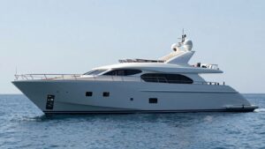 Luxurious yacht sailing on a calm, sunny sea.