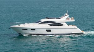 Luxurious 60-foot yacht sailing on a calm blue sea.