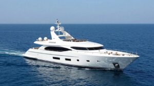 Sleek white luxury yacht on a calm blue ocean.