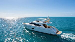 Luxurious 80-foot yacht sailing on a clear blue ocean.