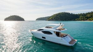 Luxury yacht sailing in Phuket's clear blue waters.