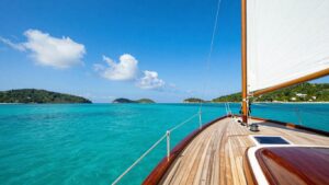 Luxurious gulet sailing on turquoise waters near islands.
