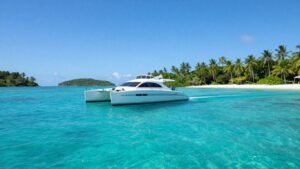Catamaran sailing in clear turquoise Bahamian waters.