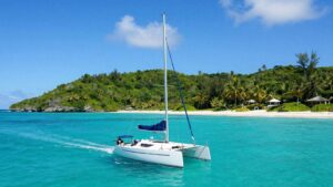 Sailboat on turquoise water near Antigua islands.