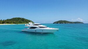Luxury yacht sailing in clear turquoise Bahamian waters.