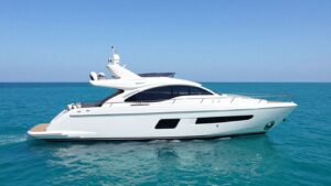 Luxurious 100-meter superyacht sailing on a clear blue ocean.