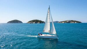 Sailboat on clear Adriatic Sea near Croatian islands.