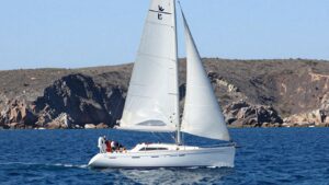 Sailboat on azure waters near La Paz coastline.