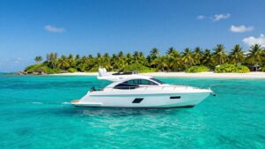 Luxury yacht sailing in clear turquoise Bahamian waters.