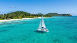 Sailboat on turquoise water in the British Virgin Islands.