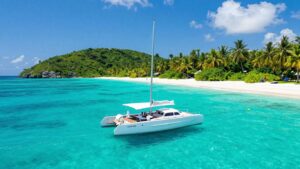 Catamaran sailing in the BVI with islands and beaches.