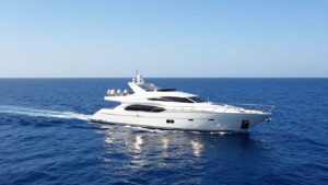 Luxury yacht sailing on a clear blue ocean.