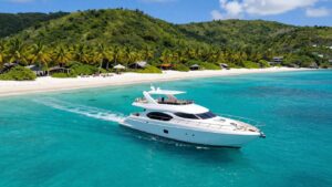 Luxury yacht approaching a tropical Caribbean island paradise.