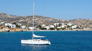 Sailboat on turquoise water near Greek island