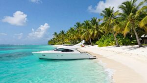 Luxury yacht sailing in clear turquoise Bahamian waters.