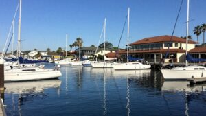 Newport Harbor Yacht Club with sailboats and building.