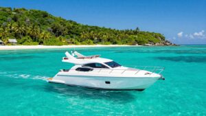 Luxury yacht sailing in clear turquoise Bahamian waters.