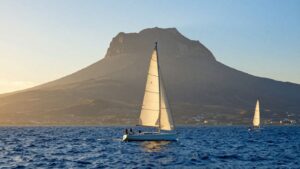 Sailboat sailing near Mount Etna, Sicily.