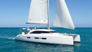 Moorings 5000 catamaran sailing on turquoise water.
