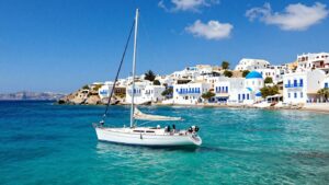 Sailboat sailing in the Aegean Sea near Greek islands.