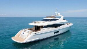 Luxury yacht sailing on a clear blue ocean.