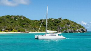 Luxury catamaran sailing in the clear turquoise waters of the Bahamas.