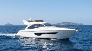 Modern yacht sailing on a sunny ocean.