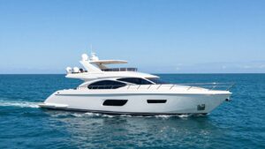 Luxury yacht sailing on a calm, blue ocean.