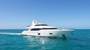 Luxurious superyacht sailing on a clear blue ocean.