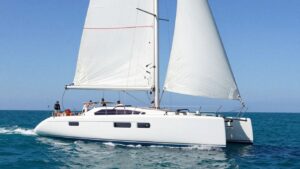 Moorings 4600 catamaran sailing on a clear blue ocean.