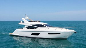 Luxury yacht sailing on a clear blue ocean.