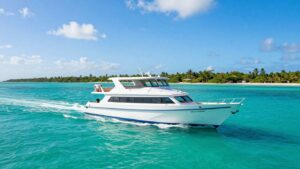 Charter boat sailing in Belize's turquoise Caribbean waters.