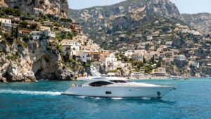Luxury yacht sailing along the stunning Italian coast of Sicily.